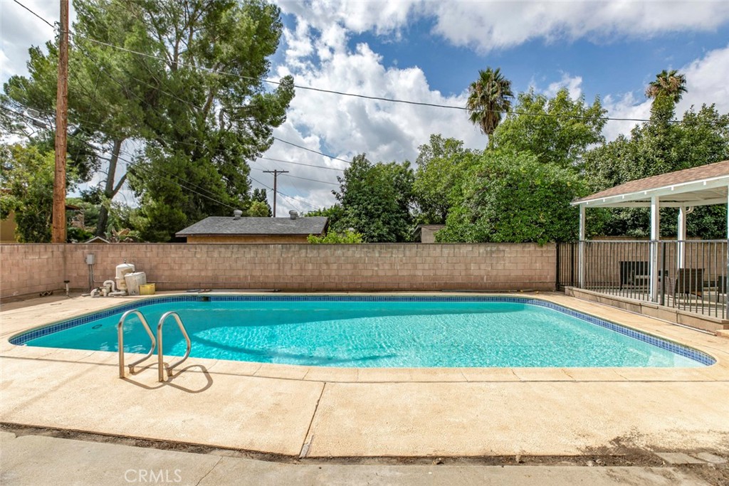 13166 Aztec Street Sylmar, CA 91342 - Photo 36 of 48 a small garden with a bench in the background