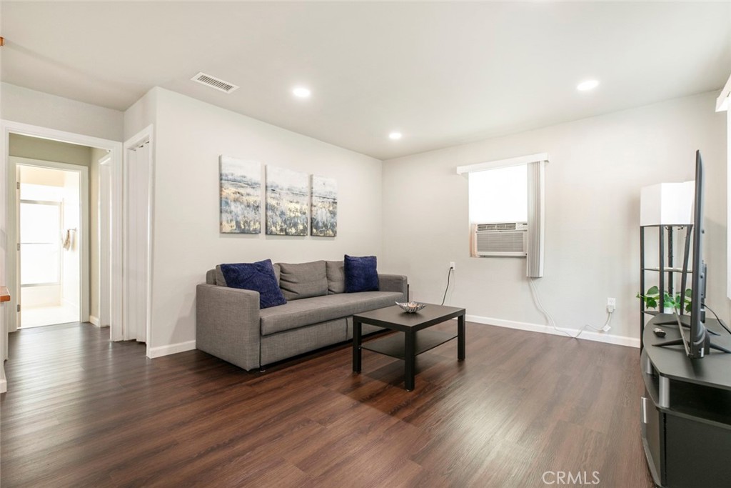 13166 Aztec Street Sylmar, CA 91342 - Photo 8 of 48 a living room with furniture and a potted plant next to a window