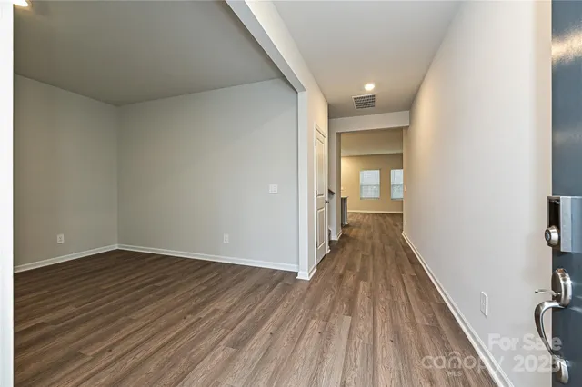 a view of a room with wooden floor