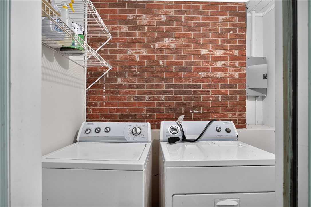 123 Robin Road Westminster, SC 29693 - Photo 43 of 50 A dedicated laundry space featuring a brick accent wall.