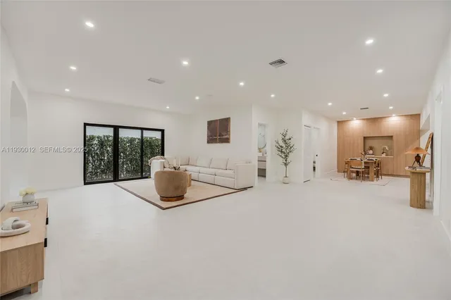 a view of a kitchen with a sink and a large window in a room