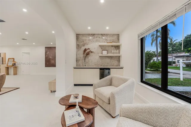 a living room with furniture and white walls