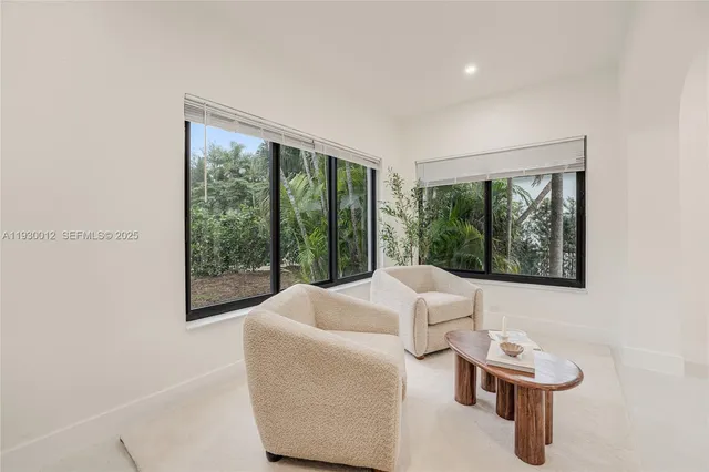 a kitchen with stainless steel appliances a sink a stove a microwave a center island and cabinets