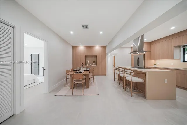 a kitchen with a dining table chairs and microwave
