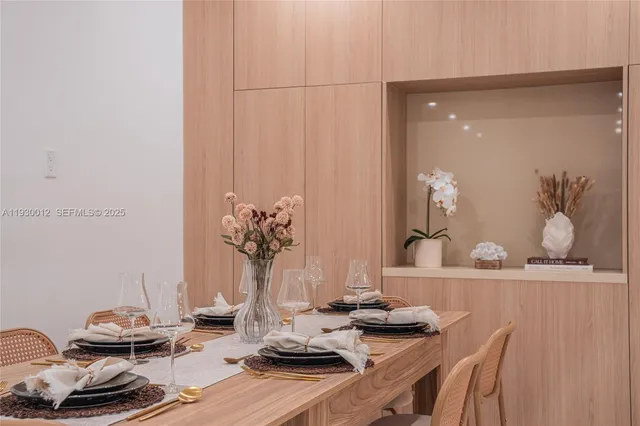 a living room with a couch and a potted plant