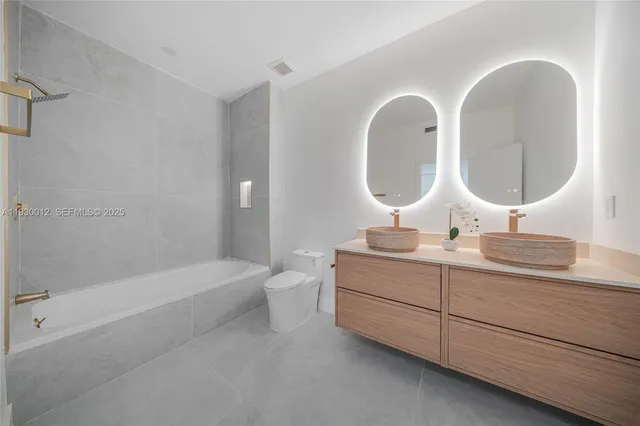 a bathroom with a sink toilet and mirror