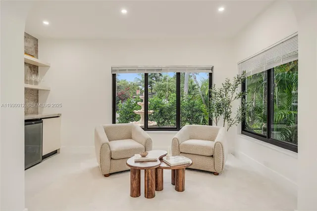 a living room with furniture and large windows