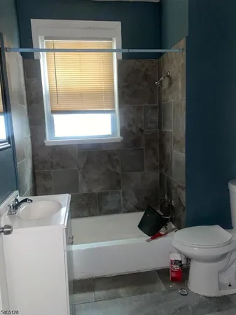 a bathroom with a toilet a sink and bathtub
