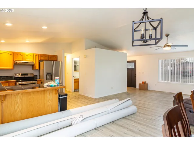 a living room with stainless steel appliances kitchen island granite countertop furniture and a kitchen view