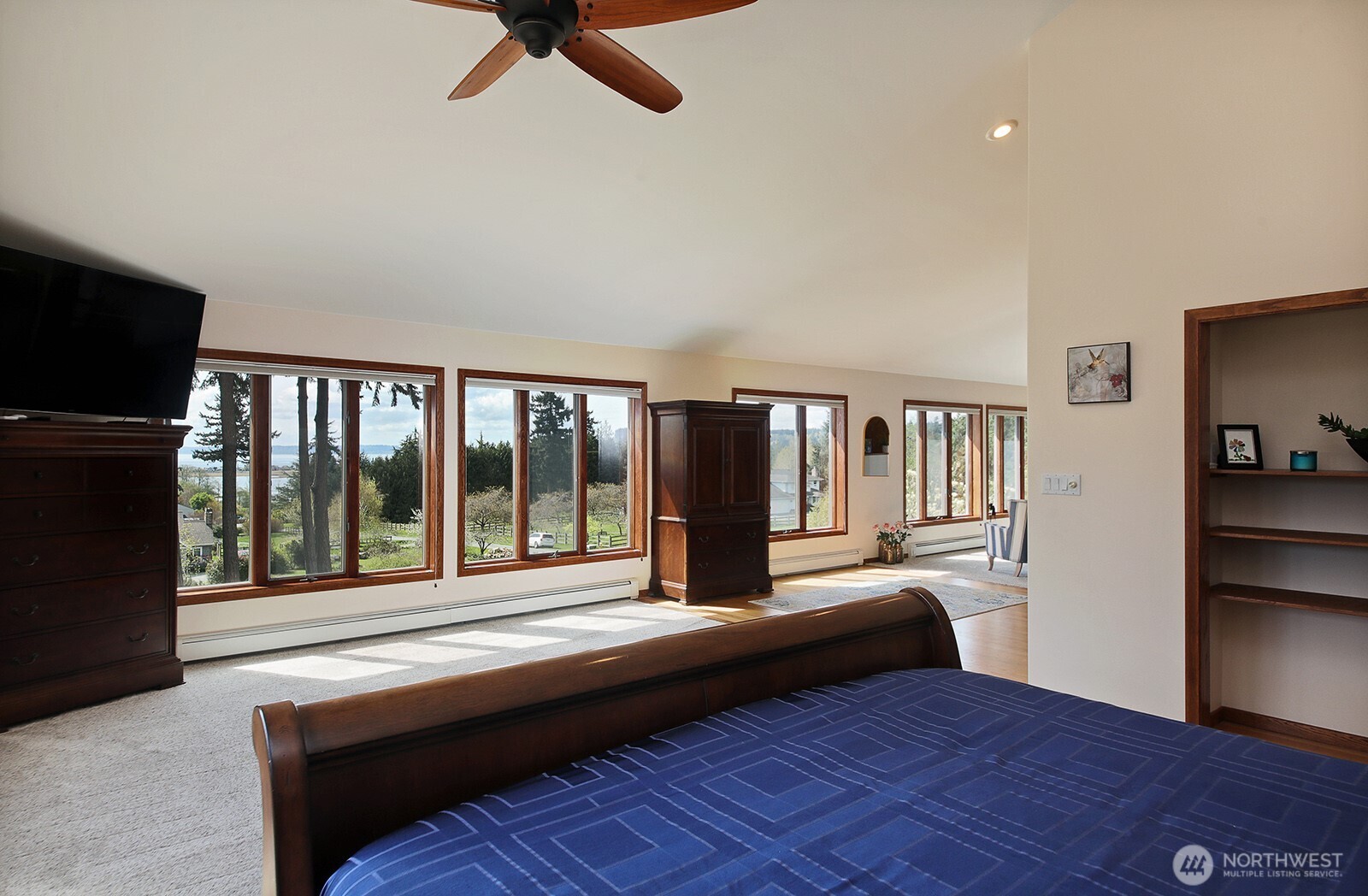 5741 Crow Haven Road Langley, WA 98260 - Photo 33 of 40 a bedroom with a bed and wooden floor