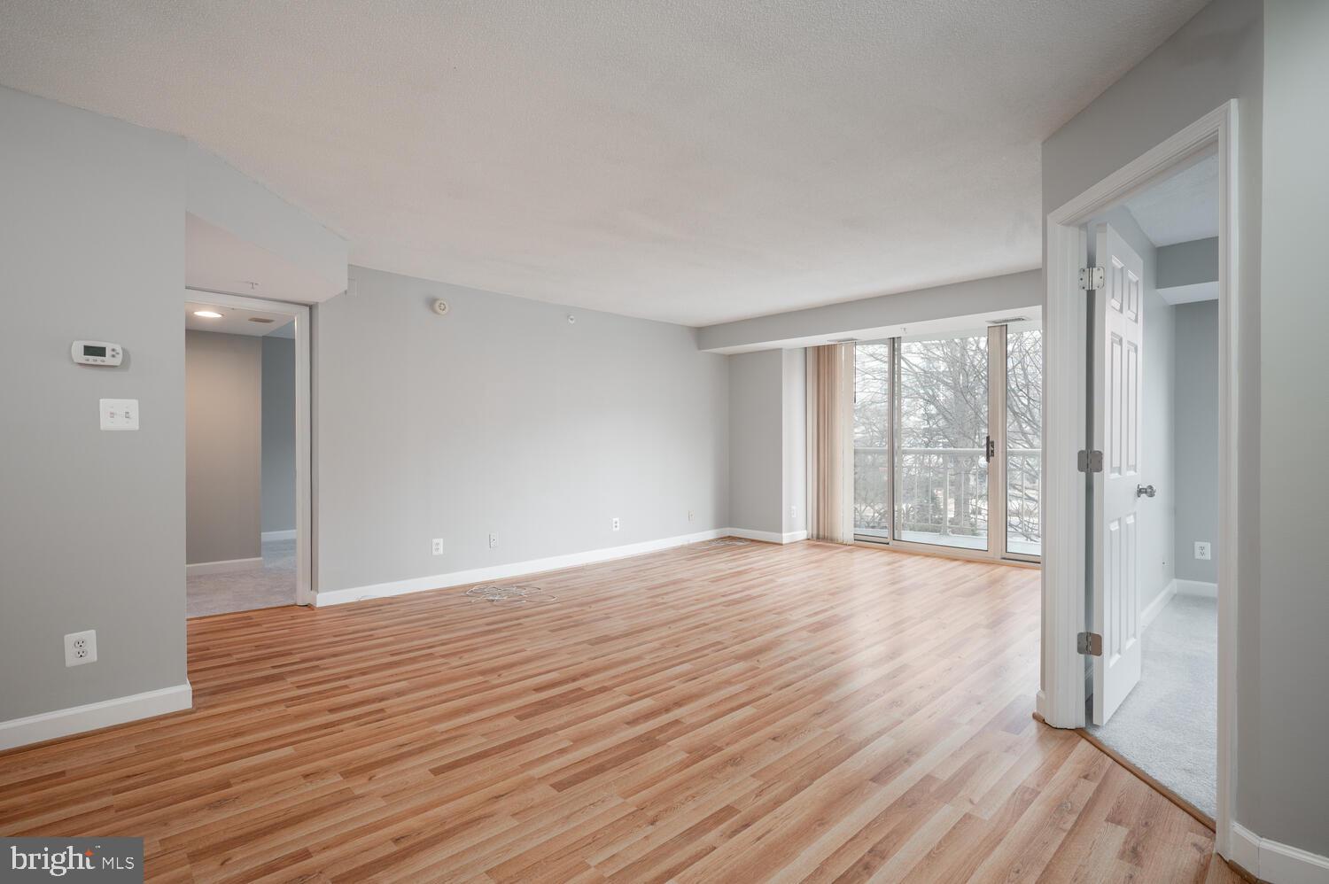 5000 Battery Lane, Unit 207 Bethesda, MD 20814 - Photo 13 of 34 a view of an empty room with wooden floor and a window