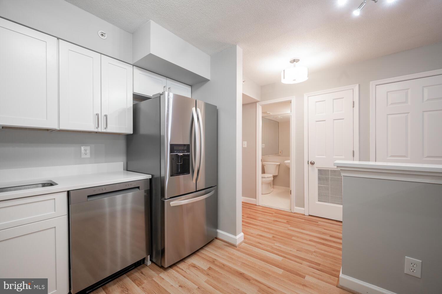 5000 Battery Lane, Unit 207 Bethesda, MD 20814 - Photo 5 of 34 a kitchen with stainless steel appliances a refrigerator and cabinets