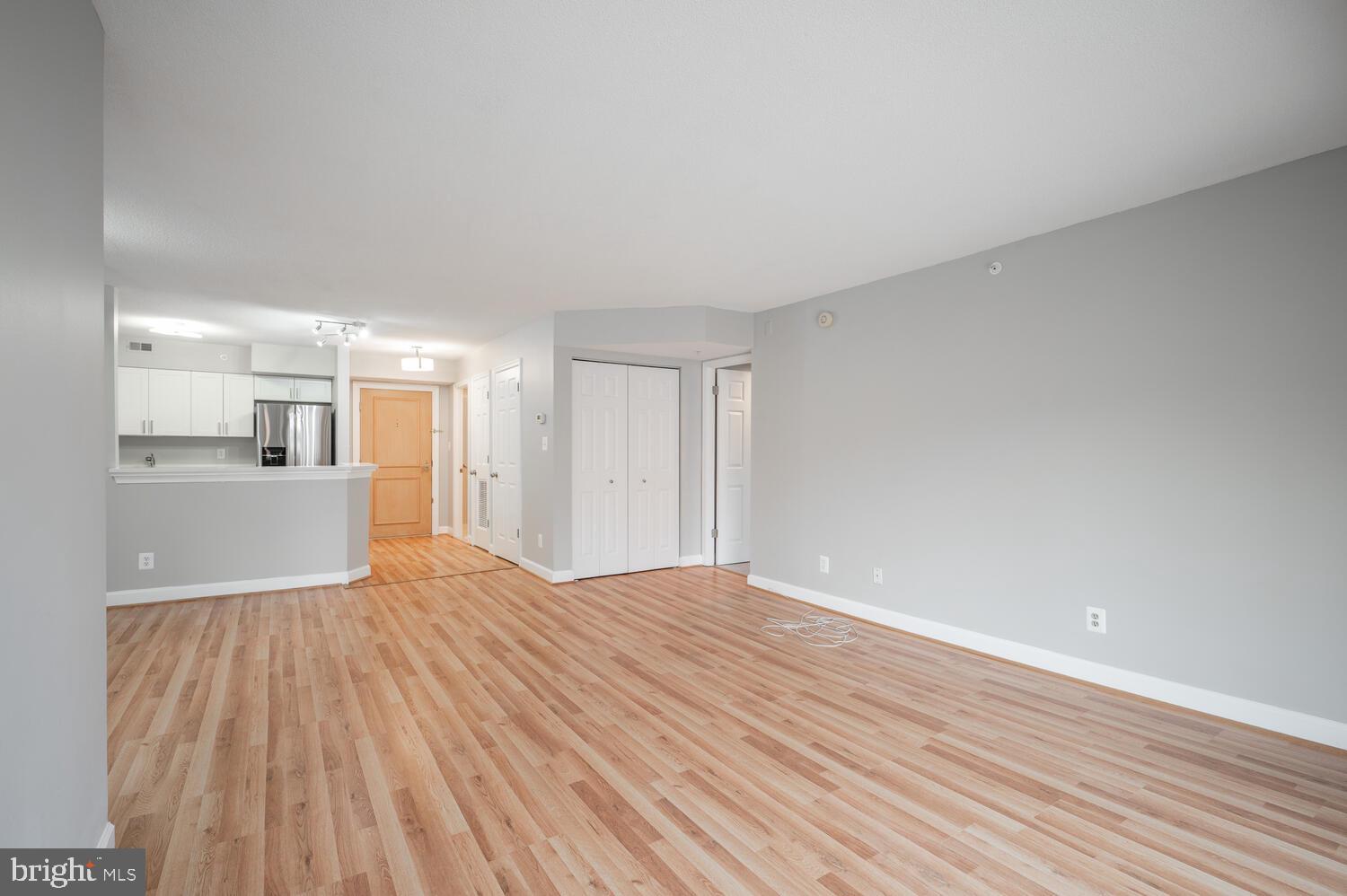 5000 Battery Lane, Unit 207 Bethesda, MD 20814 - Photo 9 of 34 a view of a kitchen with wooden floor and a kitchen