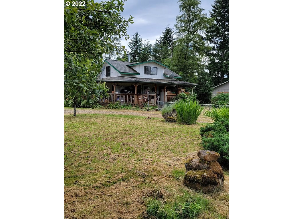 26817 Northeast Hathaway Road Camas, WA 98607 - Photo 1 of 25 a view of a house with a yard plants and large tree