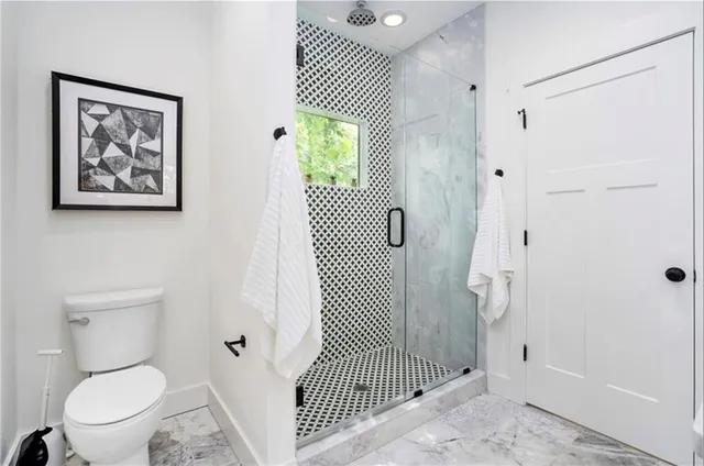 a bathroom with a toilet sink and shower