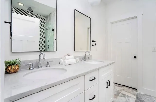 a bathroom with a double vanity sink and a mirror