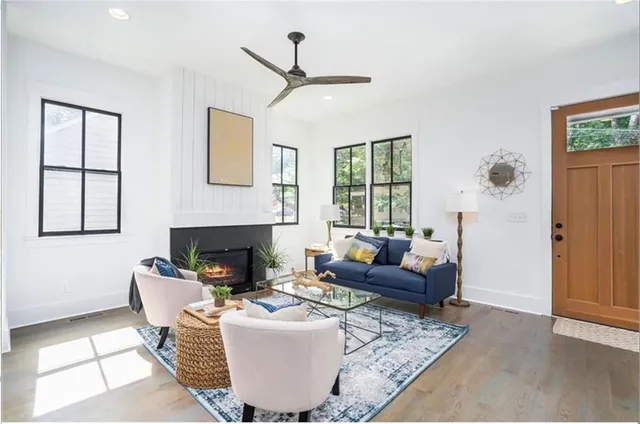 a living room with furniture a fireplace and a window