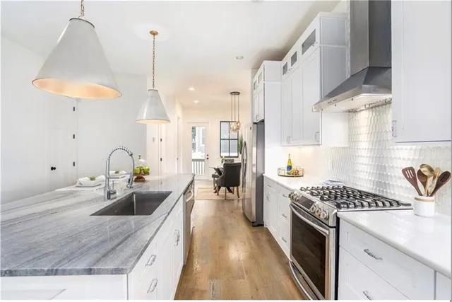 a kitchen with sink stove and cabinets