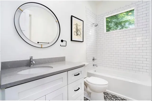 a bathroom with a sink a toilet and a mirror