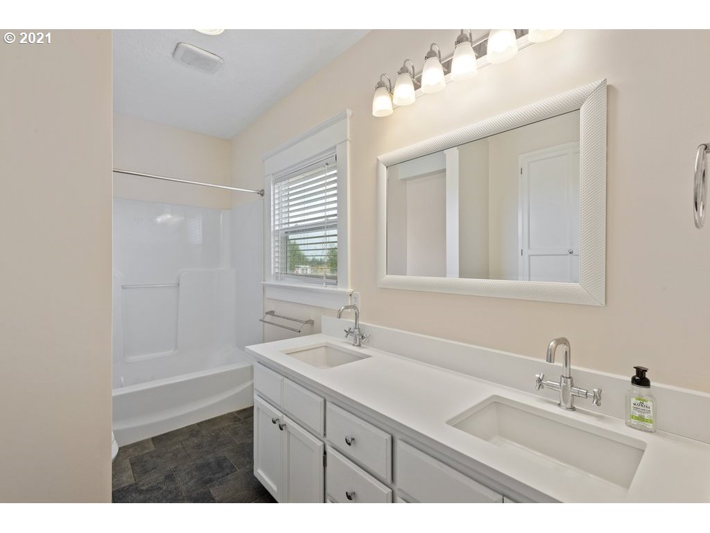 36902 South Kropf Road Woodburn, OR 97071 - Photo 12 of 26 a bathroom with a sink double vanity and a mirror