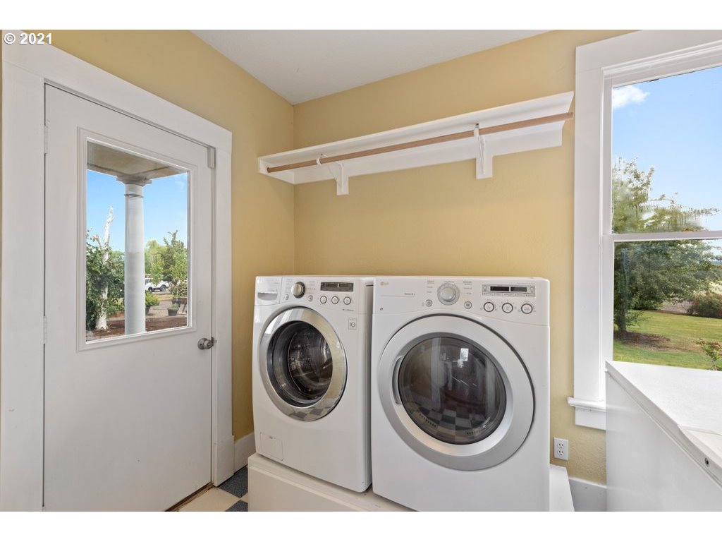 36902 South Kropf Road Woodburn, OR 97071 - Photo 13 of 26 a view of a hallway with washer and dryer