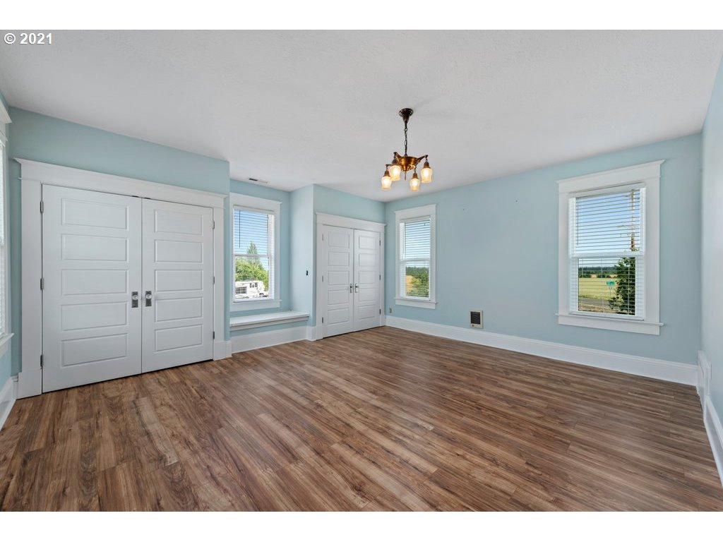 36902 South Kropf Road Woodburn, OR 97071 - Photo 14 of 26 a view of an empty room with window and wooden floor