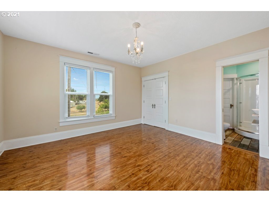 36902 South Kropf Road Woodburn, OR 97071 - Photo 18 of 26 a view of an empty room with window and wooden floor
