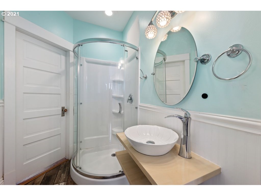 36902 South Kropf Road Woodburn, OR 97071 - Photo 22 of 26 a bathroom with a sink a mirror a toilet and shower