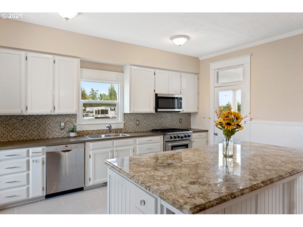 36902 South Kropf Road Woodburn, OR 97071 - Photo 5 of 26 a kitchen with stainless steel appliances granite countertop a sink a stove and cabinets