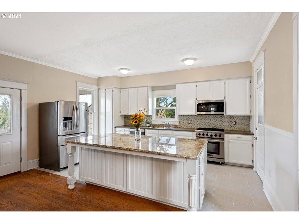 36902 South Kropf Road Woodburn, OR 97071 - Photo 7 of 26 a kitchen with stainless steel appliances granite countertop a stove top oven a refrigerator and a granite counter tops