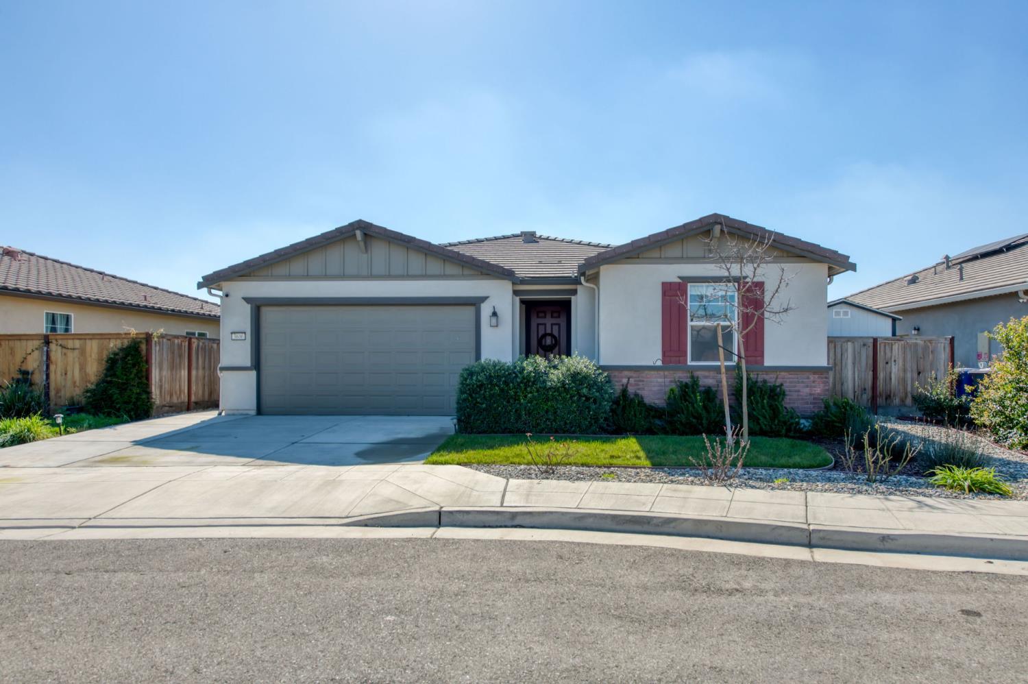 3606 Morro Rock Place Madera, CA 93637 - Photo 1 of 46 a front view of a house with a yard and garage