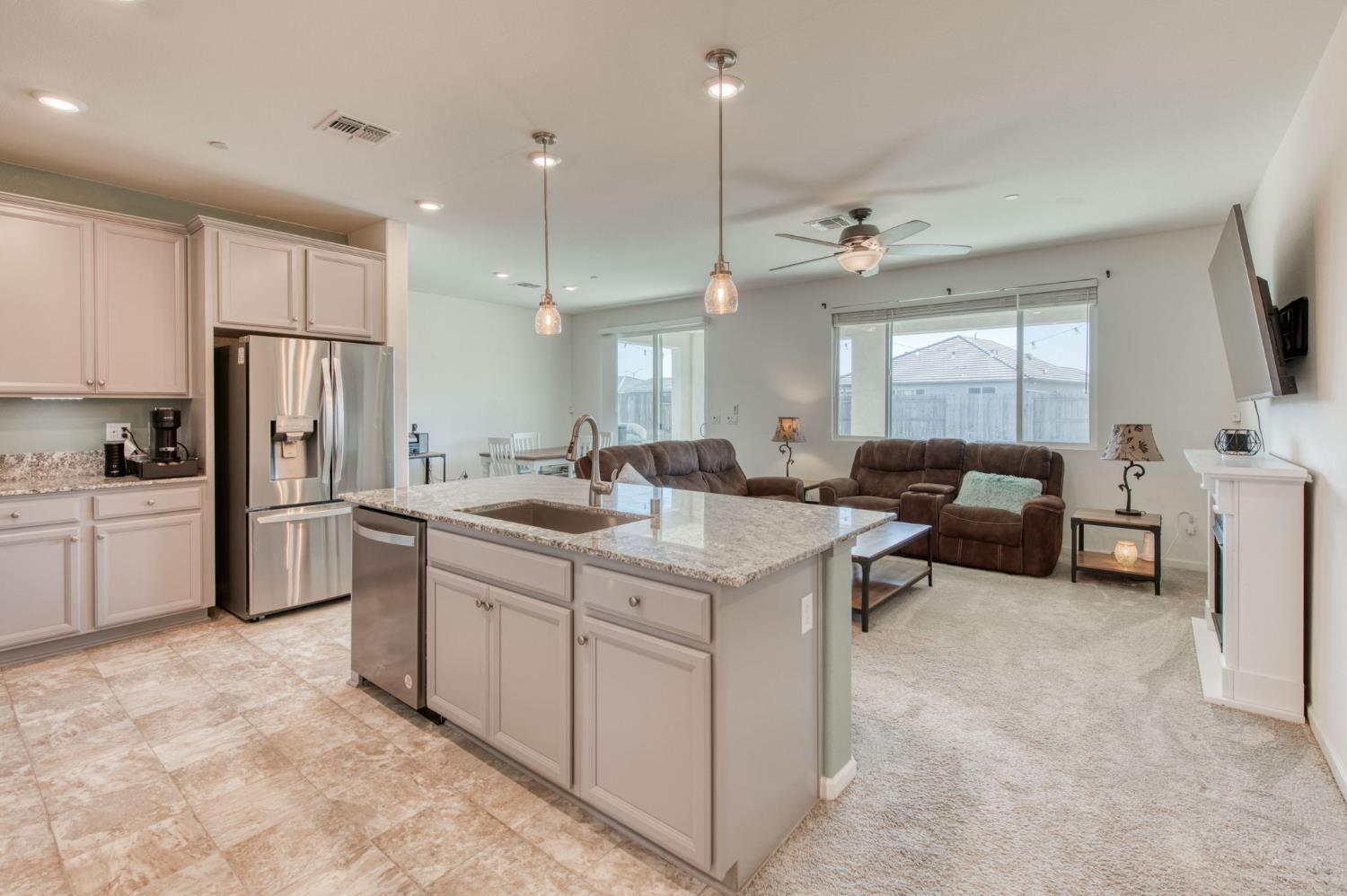 3606 Morro Rock Place Madera, CA 93637 - Photo 11 of 46 a kitchen with sink refrigerator and cabinets