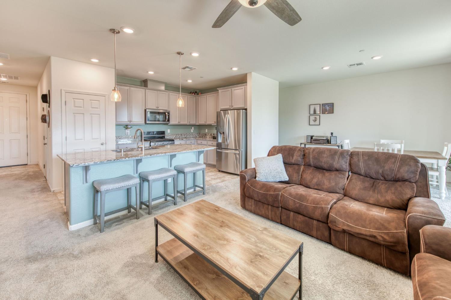 3606 Morro Rock Place Madera, CA 93637 - Photo 22 of 46 a living room kitchen with a couch and a view of kitchen