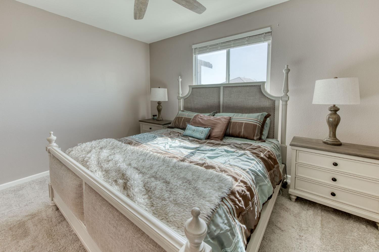 3606 Morro Rock Place Madera, CA 93637 - Photo 27 of 46 a bedroom with a bed and window