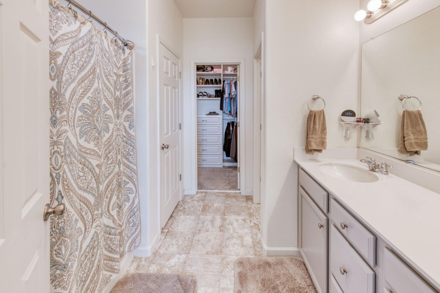 3606 Morro Rock Place Madera, CA 93637 - Photo 29 of 46 a bathroom with a sink and a mirror