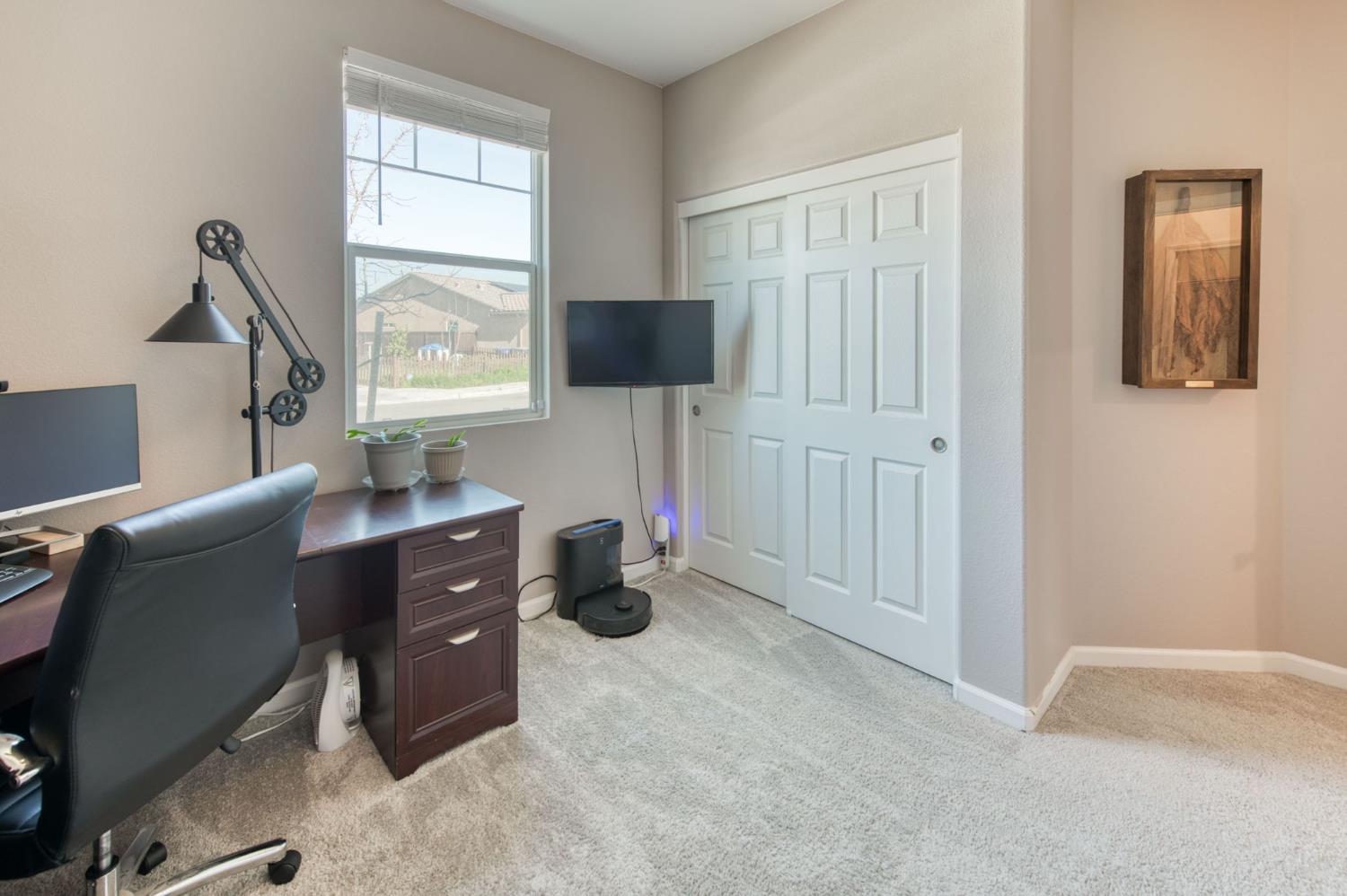 3606 Morro Rock Place Madera, CA 93637 - Photo 37 of 46 a livingroom with workspace and a window