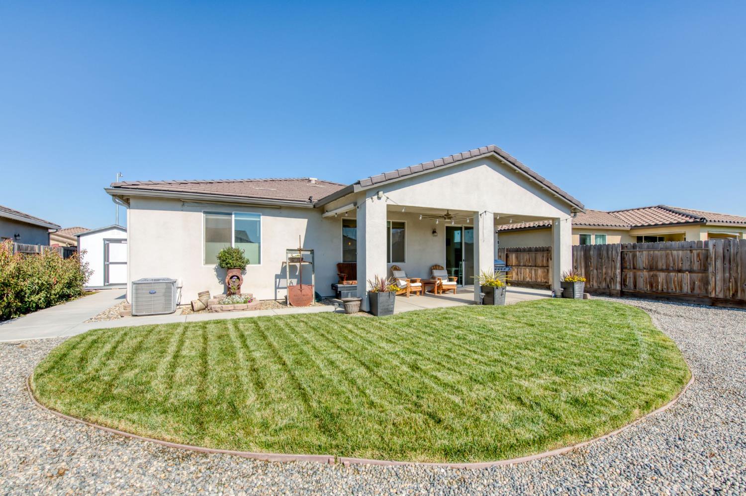 3606 Morro Rock Place Madera, CA 93637 - Photo 42 of 46 a view of a house with backyard porch and patio