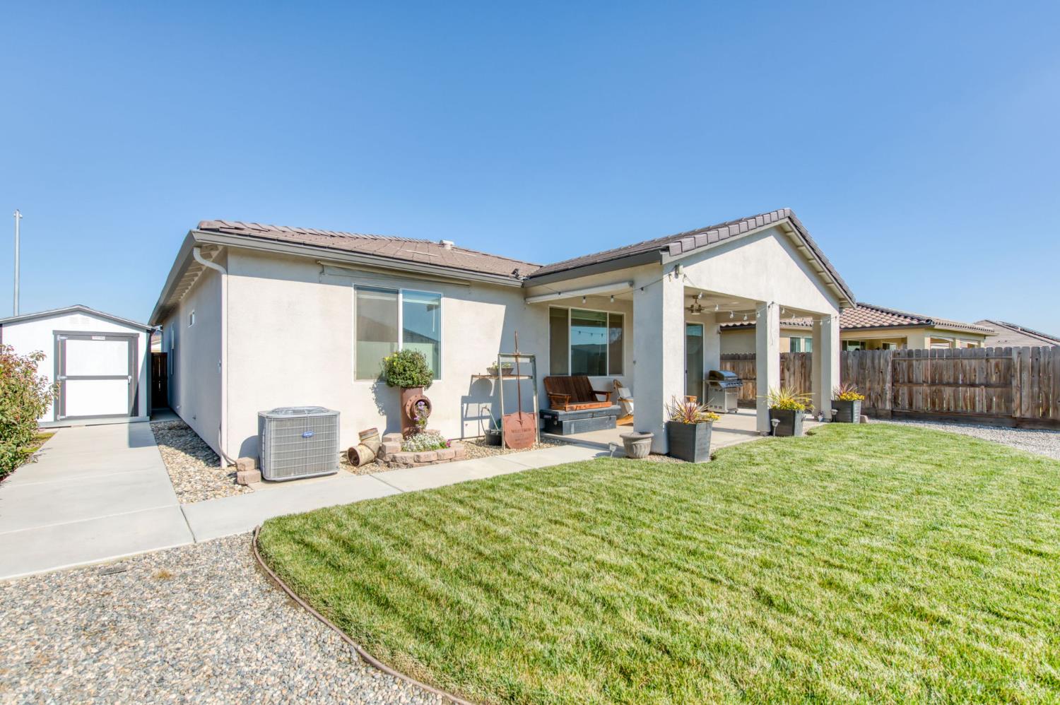 3606 Morro Rock Place Madera, CA 93637 - Photo 43 of 46 a view of a house with backyard porch and sitting area