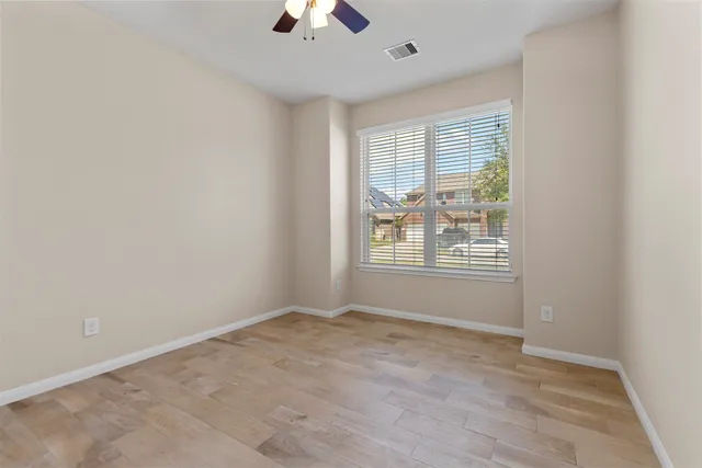 an empty room with windows and closet