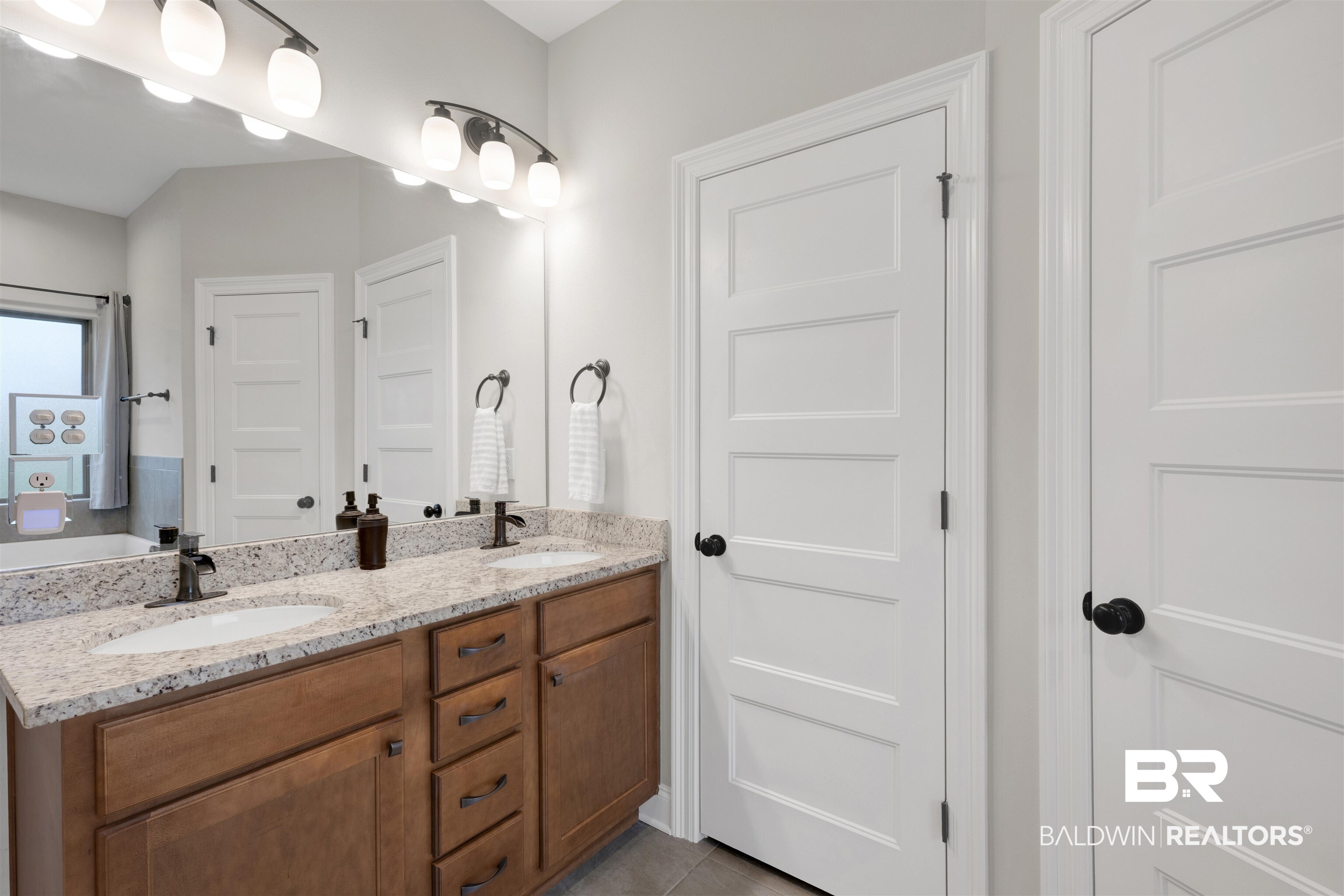 12672 Squirrel Drive Daphne, AL 36527 - Photo 25 of 49 Double vanity featuring a light-toned countertop, dual undermount sinks, and dark bronze fixtures