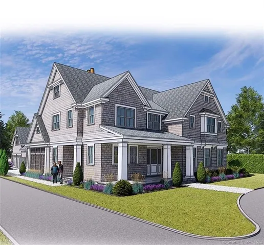 a front view of a house with a garden and yard