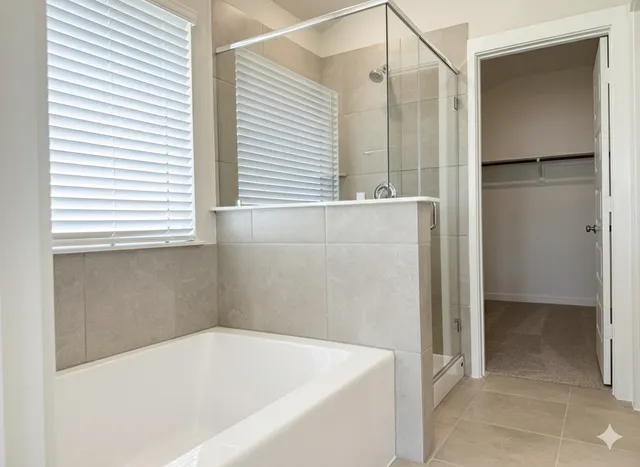 a bathroom with a bathtub and a shower