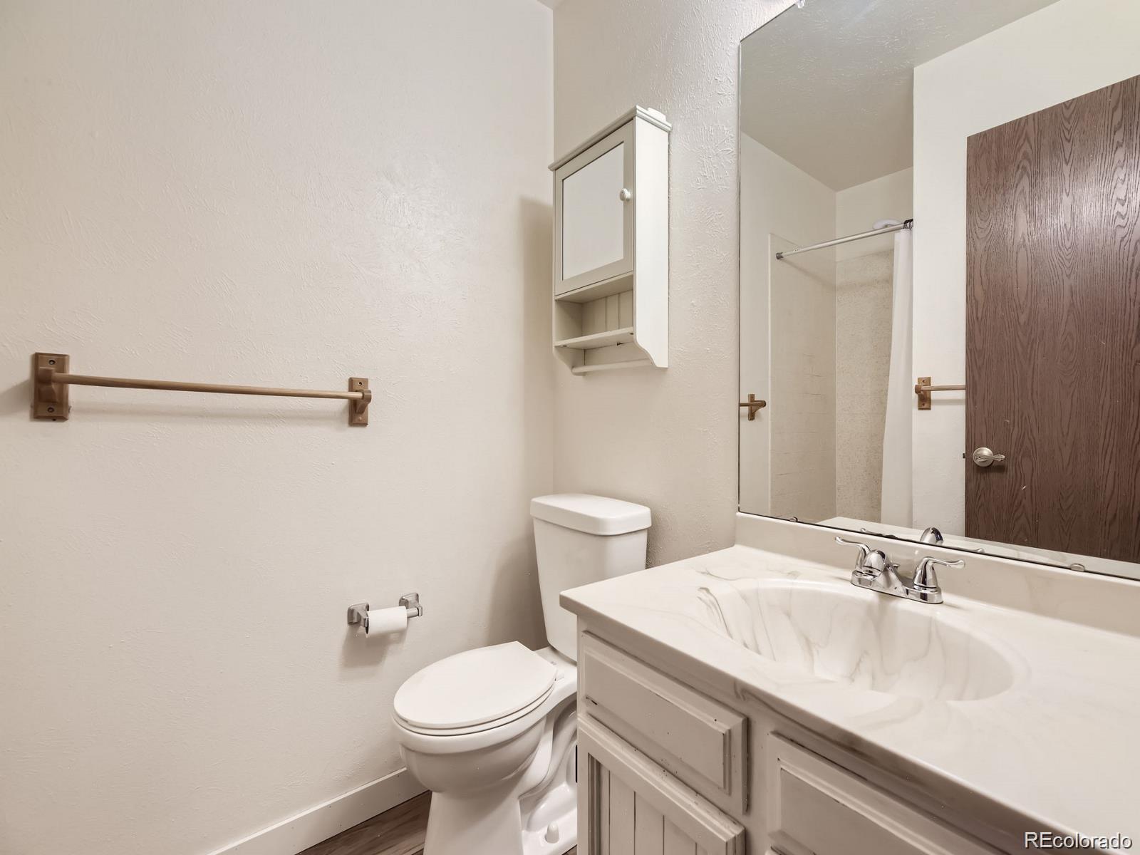 2949 Shady Hollow East Boulder, CO 80304 - Photo 15 of 31 a bathroom with a sink toilet and shower