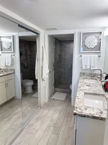a bathroom with a granite countertop sink and a mirror