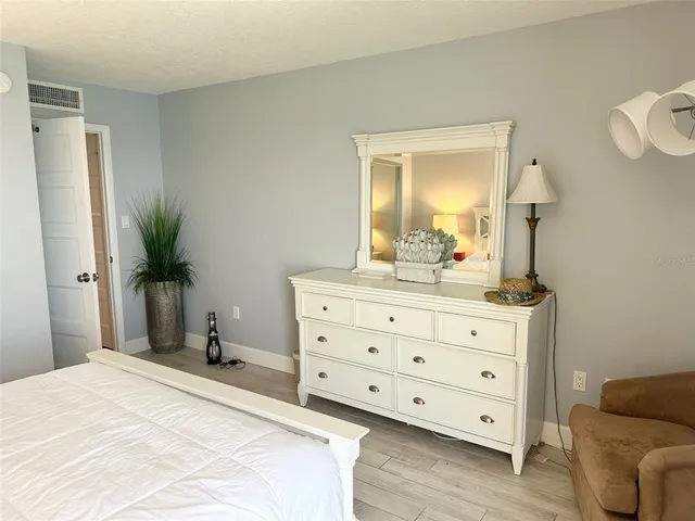 a bedroom with a bed and a dresser