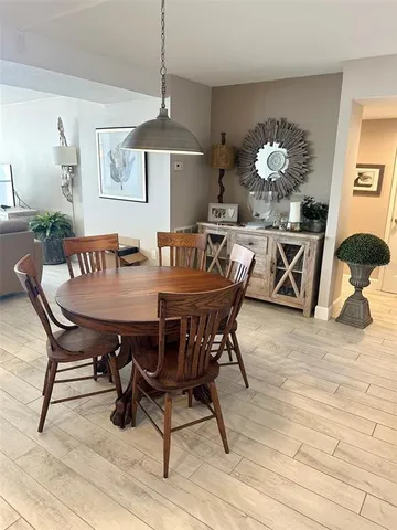 a dining room with furniture a rug and wooden floor