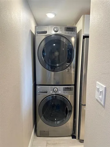 a utility room with washing machine and a washer dryer