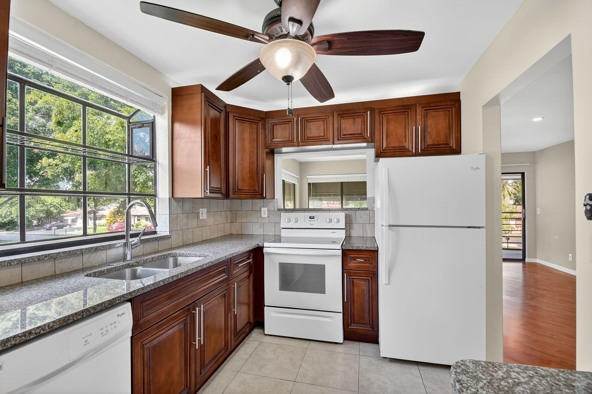 5040 Rose Hill Drive, Unit 206 Boynton Beach, FL 33437 - Photo 15 of 54 a kitchen with stainless steel appliances granite countertop a refrigerator a sink a stove and a microwave