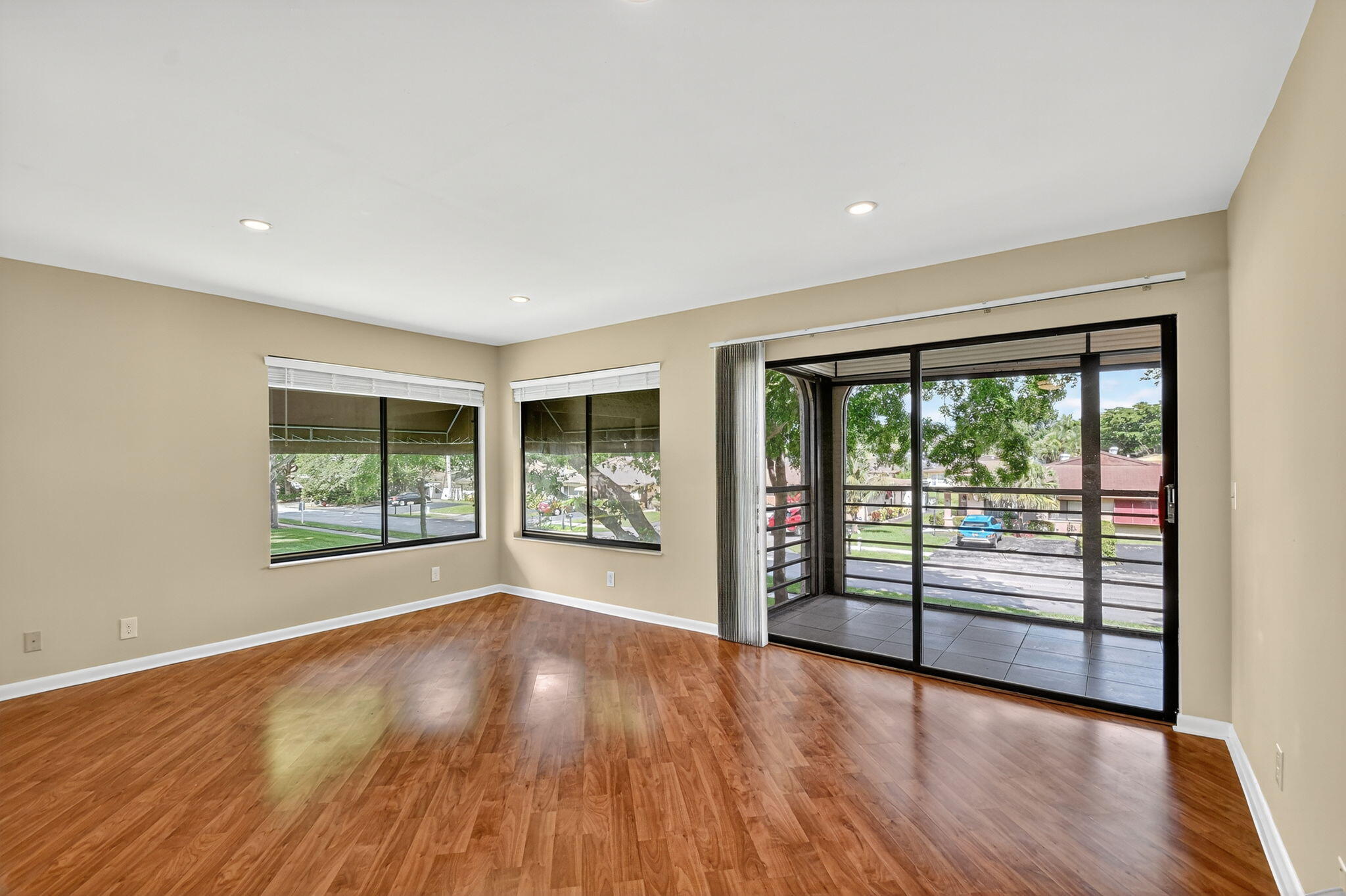 5040 Rose Hill Drive, Unit 206 Boynton Beach, FL 33437 - Photo 16 of 54 an empty room with wooden floor and windows