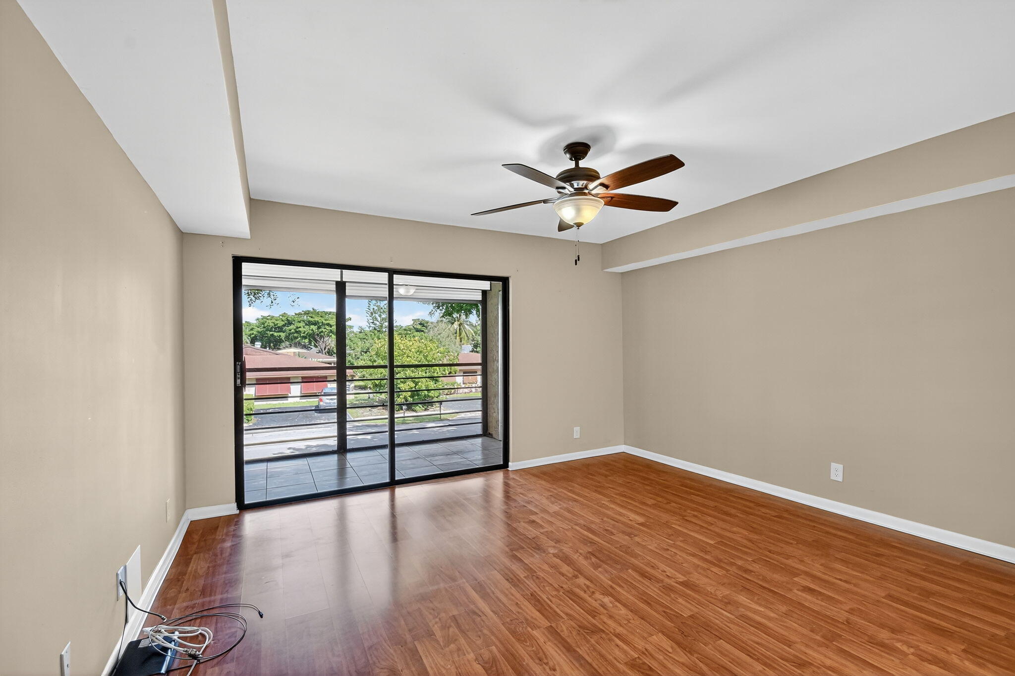 5040 Rose Hill Drive, Unit 206 Boynton Beach, FL 33437 - Photo 24 of 54 an empty room with wooden floor and windows